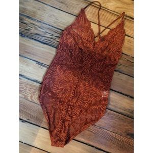 Nasty Gal burnt orange/rust colored lace body suit